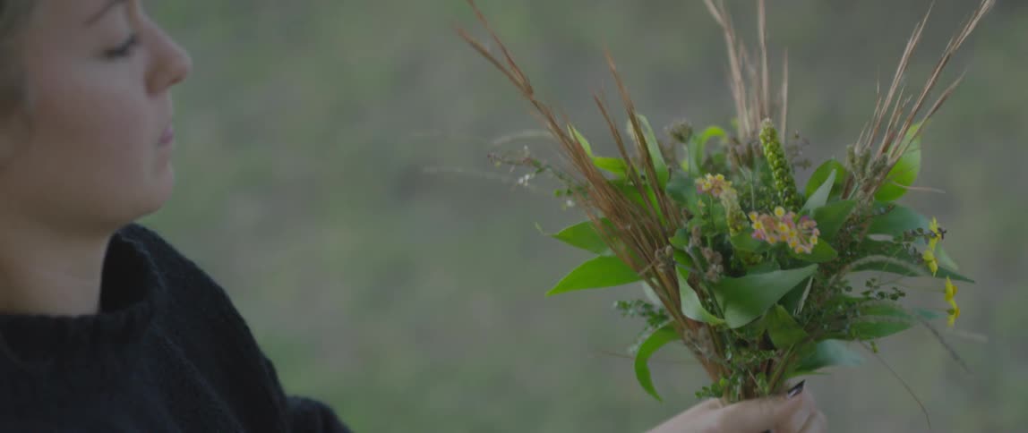 Woman working on a bouquet in her hands