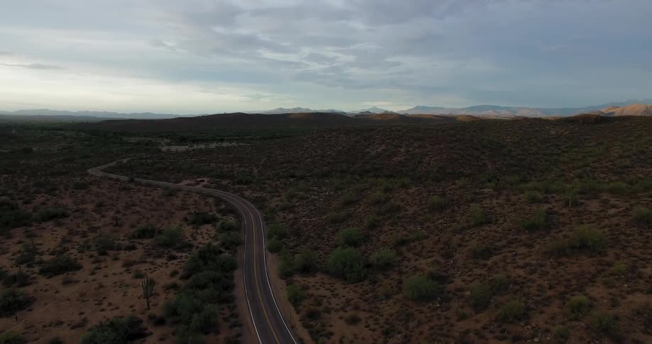 Road winds through bush covered plains