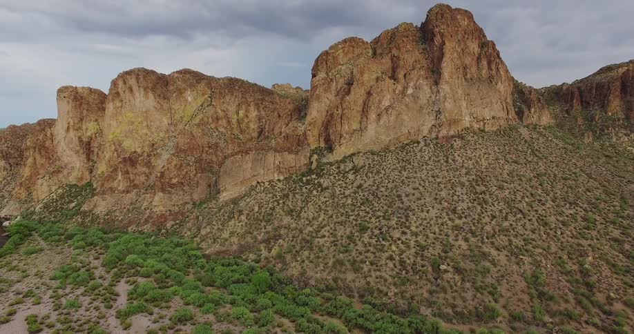 Tall rocky hills and clouds overhead