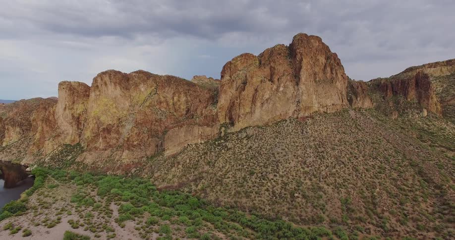 Clouds float above rocky cliff sides in the wilderness