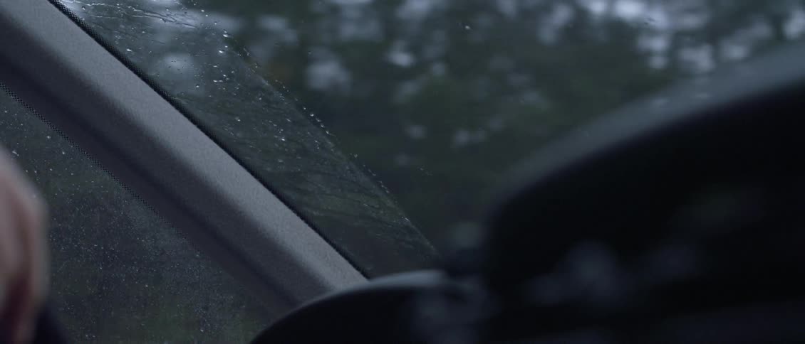 Water beads on the windshield of the car