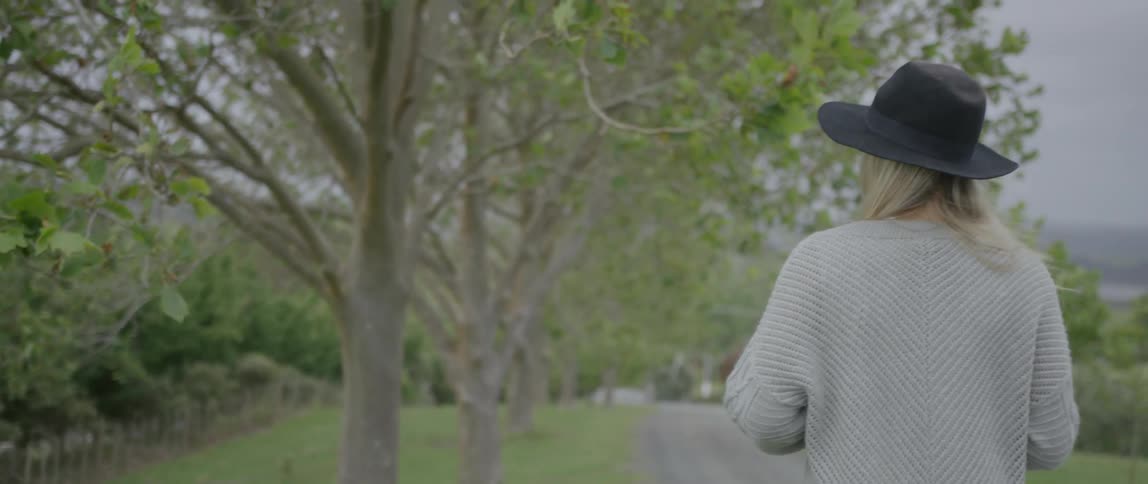 A woman walks through the woods