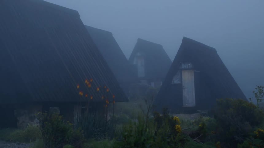 Small triangle-shaped building sit together on a very overcast day