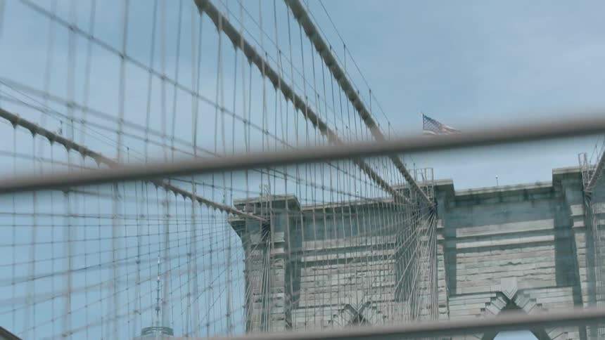 A car is traveling along a bridge