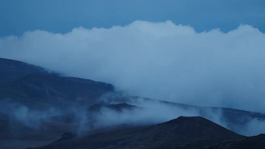 Fog rolls over hilly land