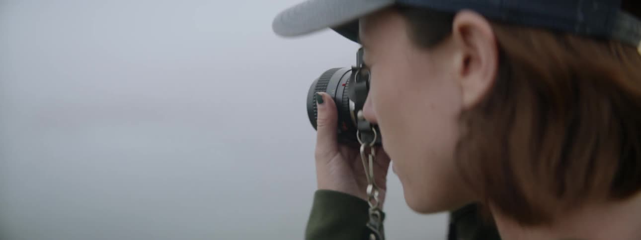 Woman taking photographs of nature on a cloudy day