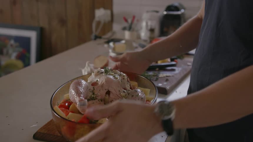 A man prepares a turkey for the oven