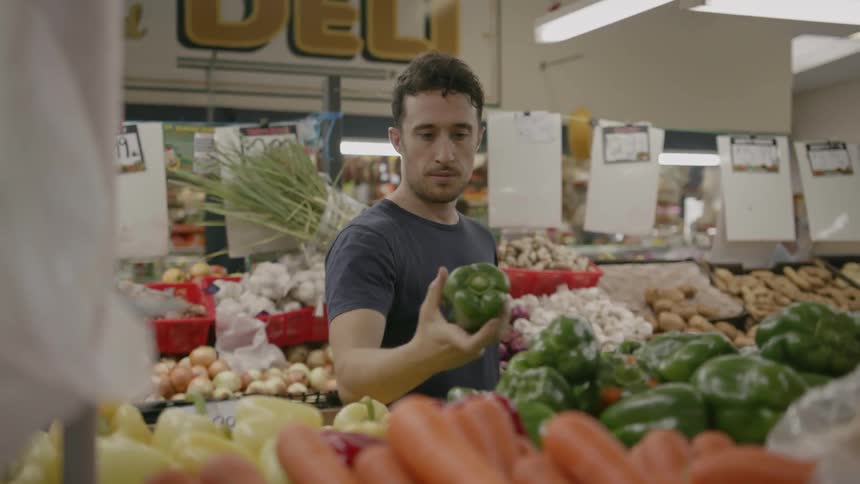 A man shops for produce at a market