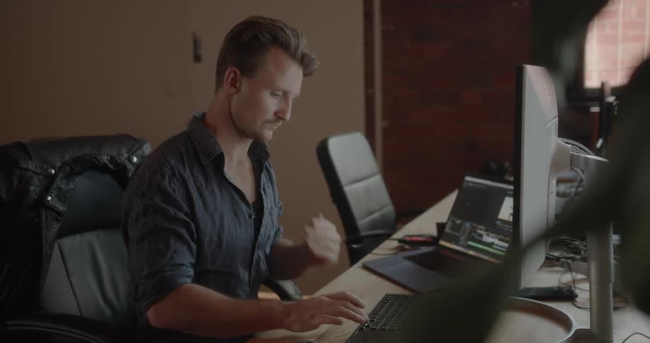 A man sits at a desk in an office