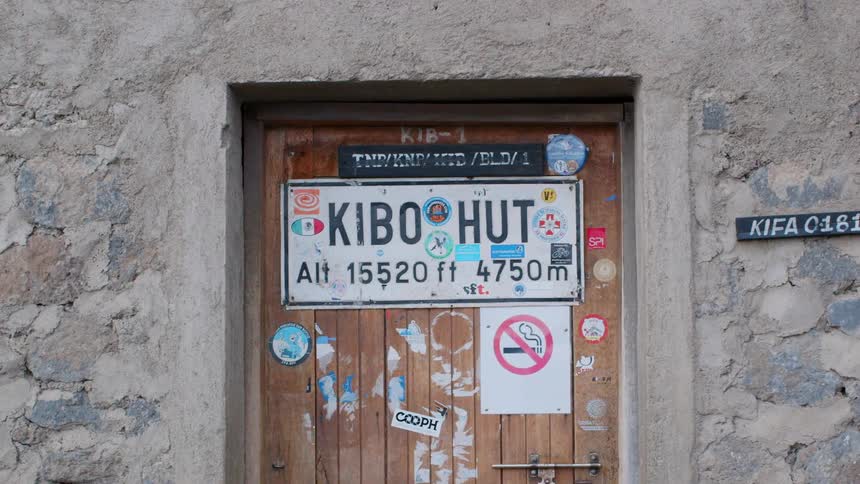 The wooden door is covered in signs
