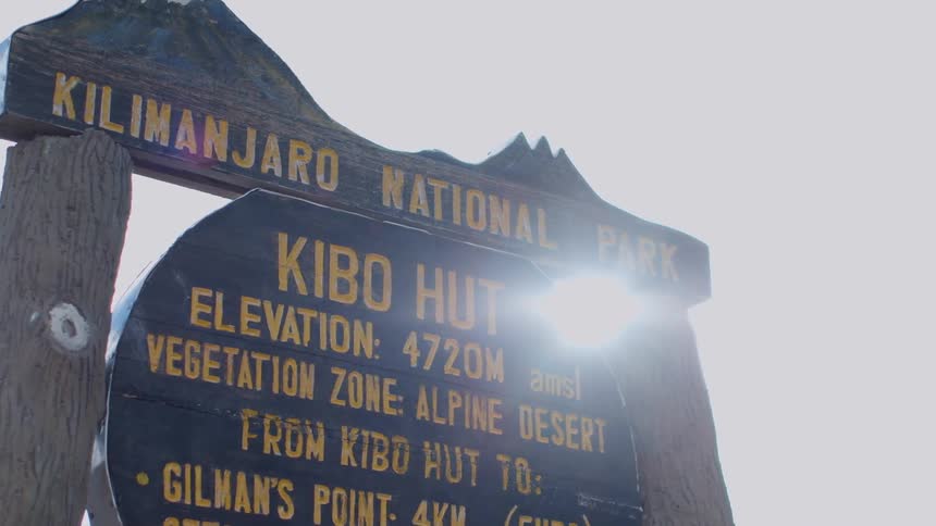Sunlight shines behind a national park sign