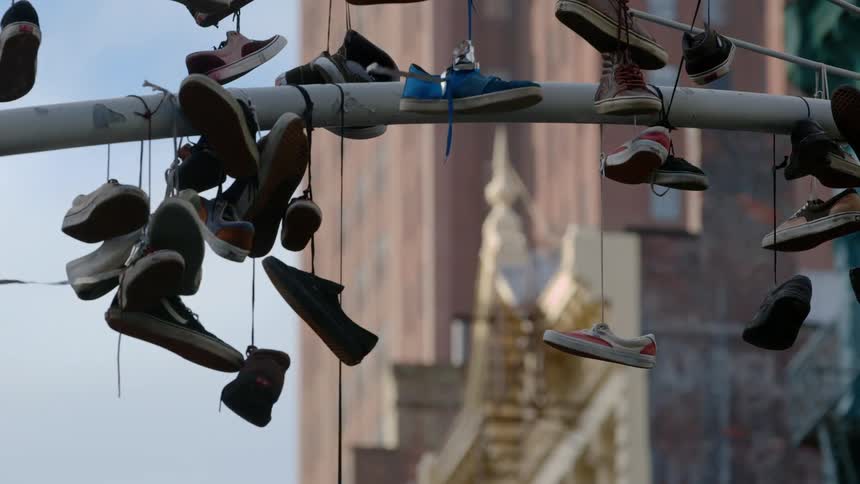 Shoes hang from steel beams