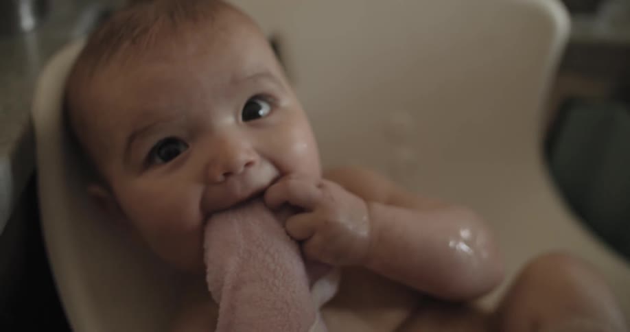 An infant is bathed