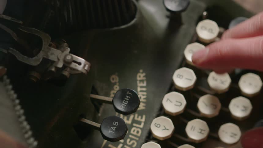 Someone is typing on an old typewriter