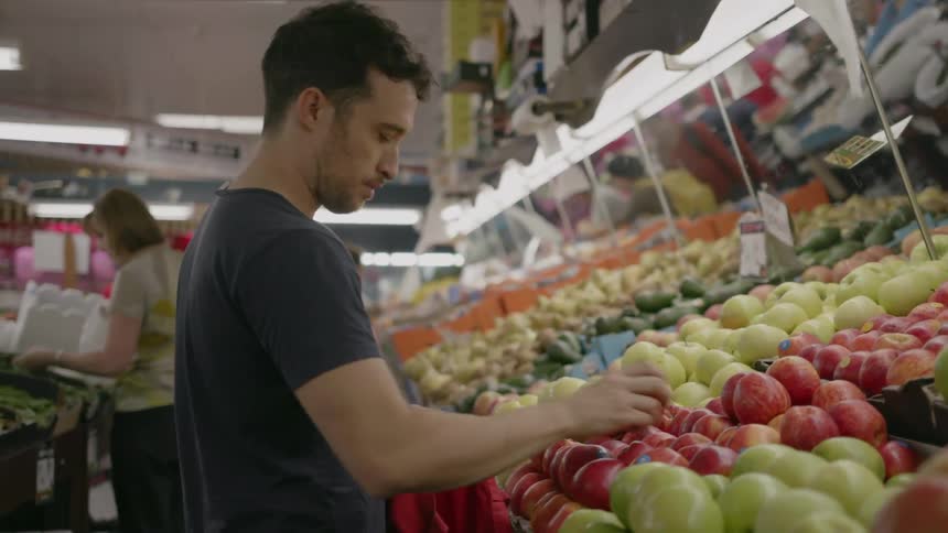 A man shops for produce at a market
