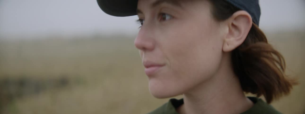 A woman exhales and looks at nature