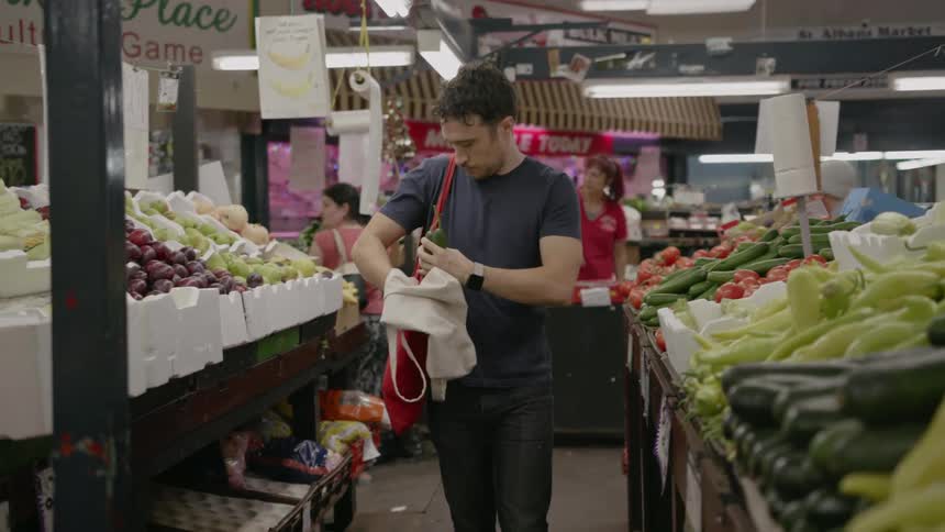 A man shops for produce at a market