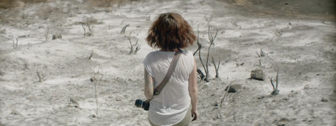 Woman walks in the desert on a sunny day