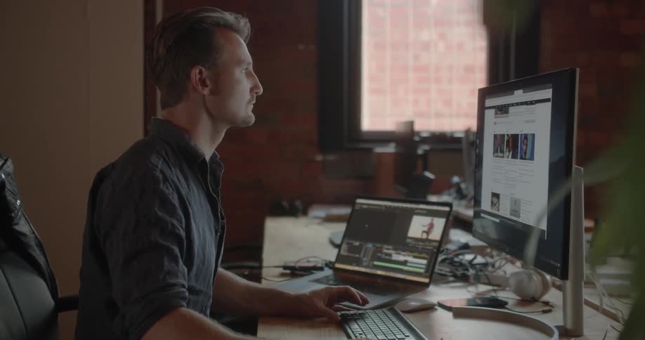 A man is working on the computer in the office