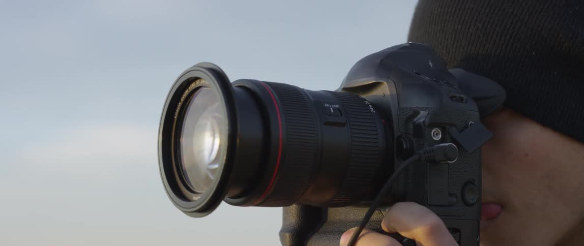 Person using a camera with a long lens