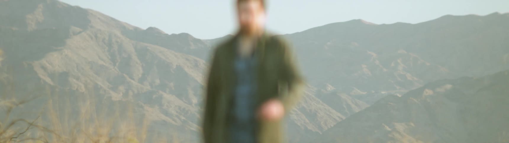 Man walking across a mountain top