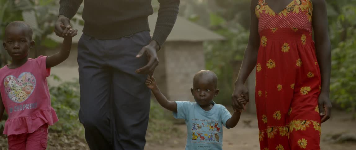 A man and woman walk with two young children