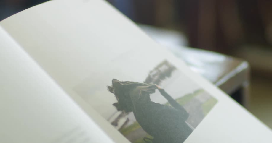 A person turns the page of a book