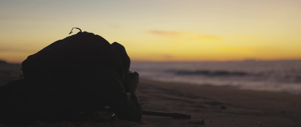 A man photographs the beach