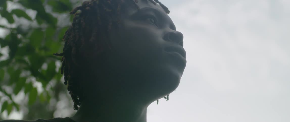Person standing outside on a cloudy day looks up