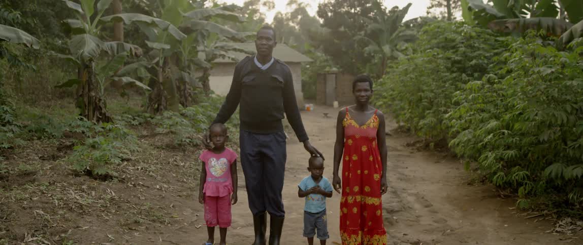 A family stand together on the dirt trail