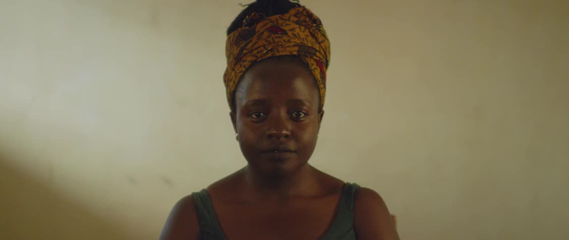 A woman is standing in a room smiling