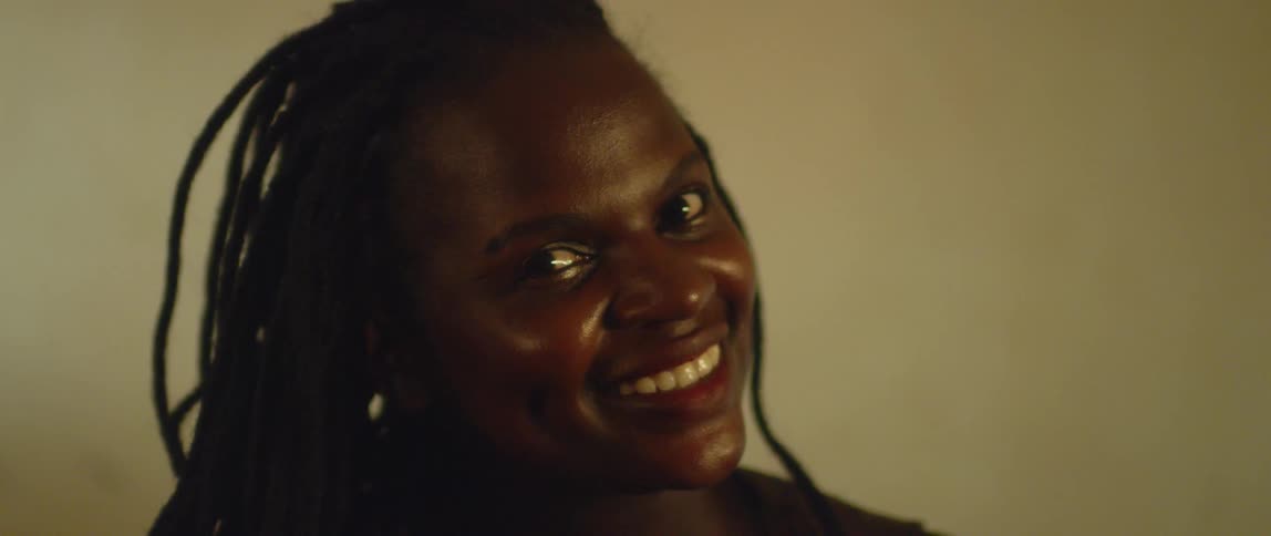 A woman tilts her head and smiles
