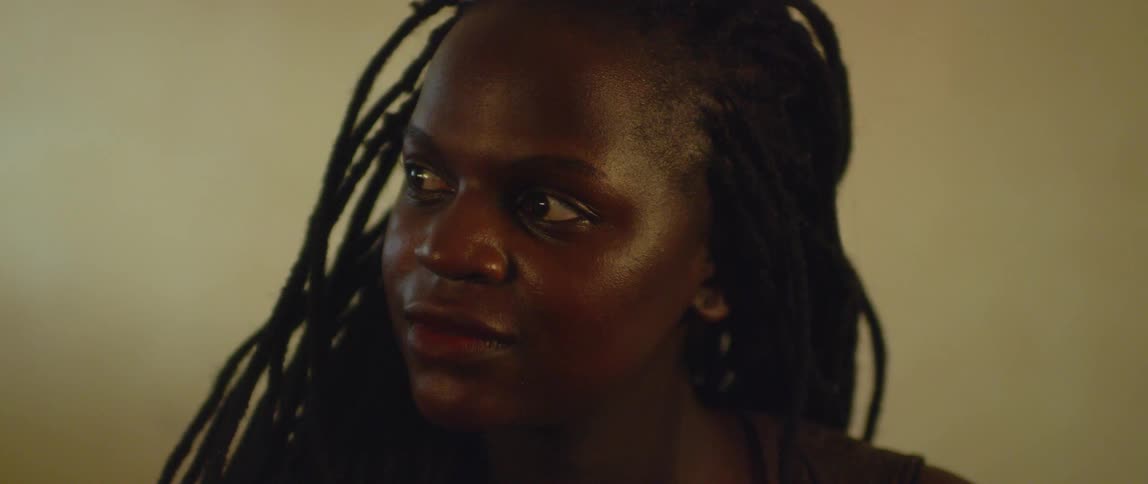A woman looks off to her side