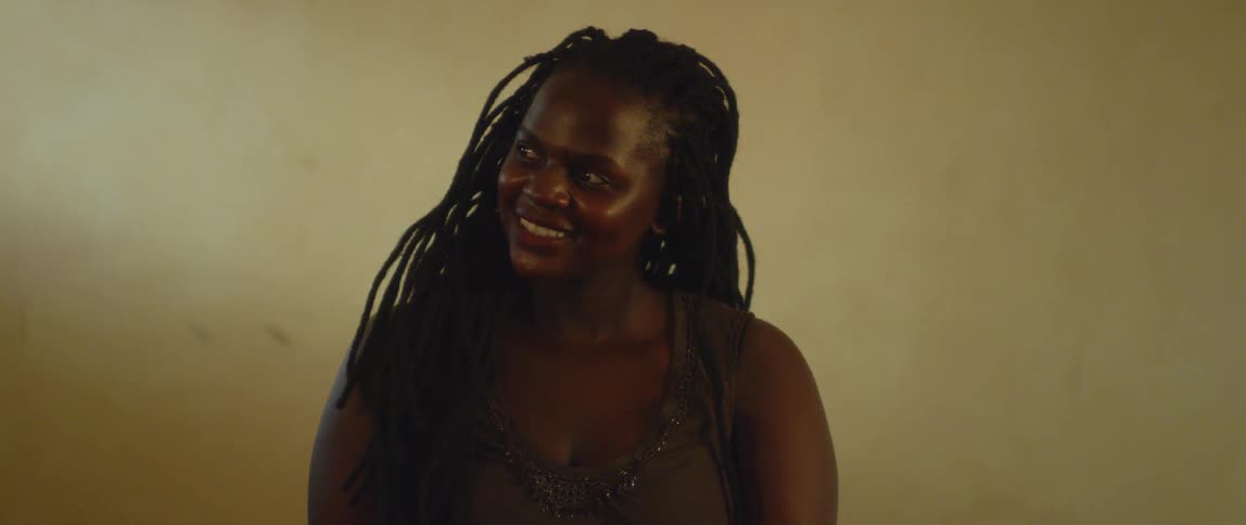 A woman smiles and looks to the side