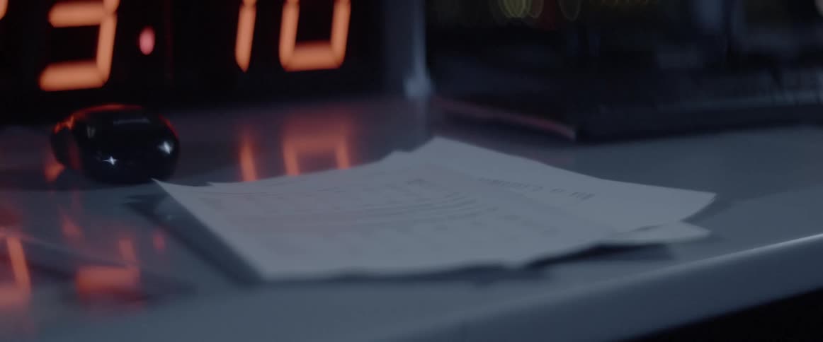 A sheet of paper with text is dropped onto a pile of others