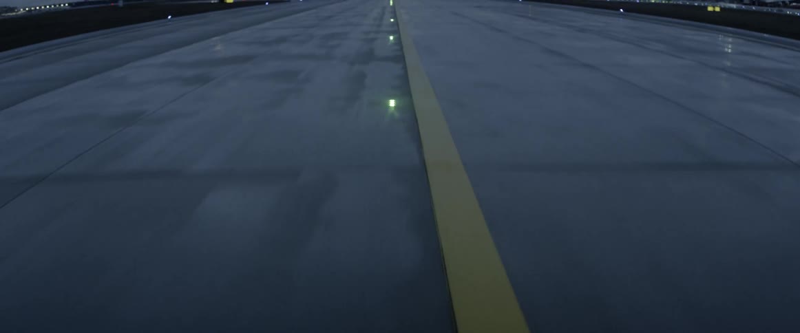 Plane is traveling down the runway of an airport