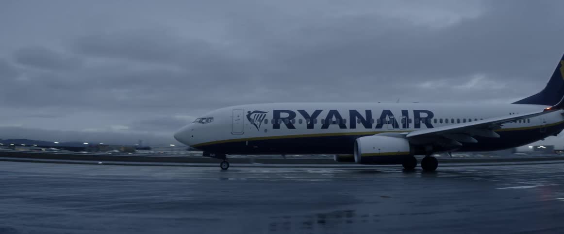 A passenger plane is taxing the runway of an airport
