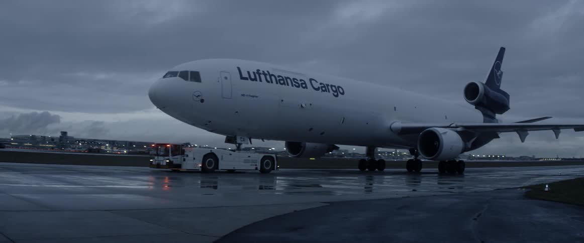 A cargo jet is towed on the tarmac