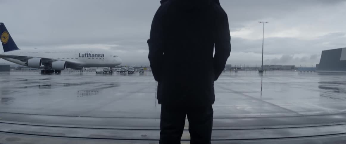 A man stands on an airport tarmac