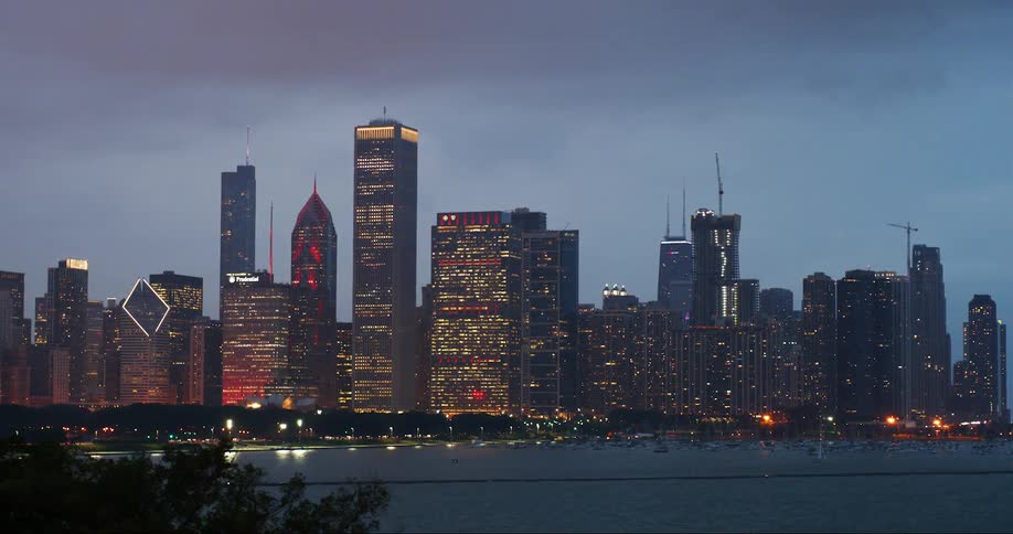 City buildings and skyscrapers lit up after sunset