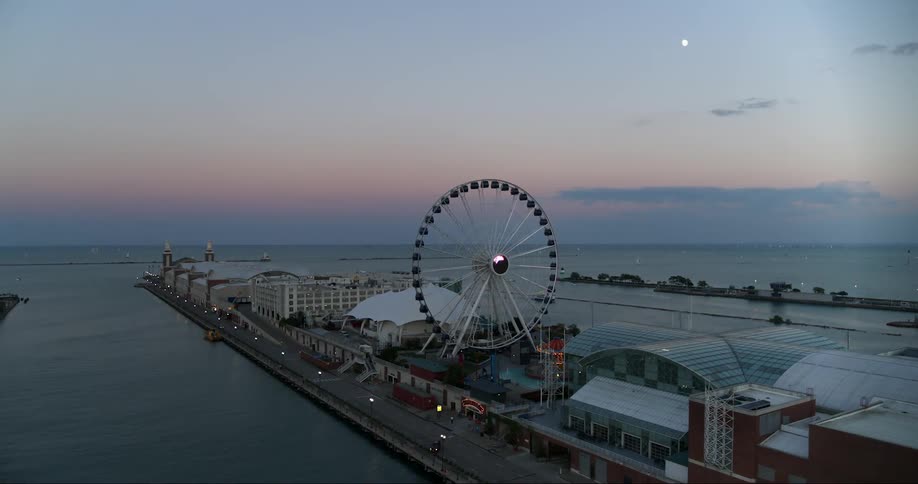 Ferris wheel on a pier surrounded by water