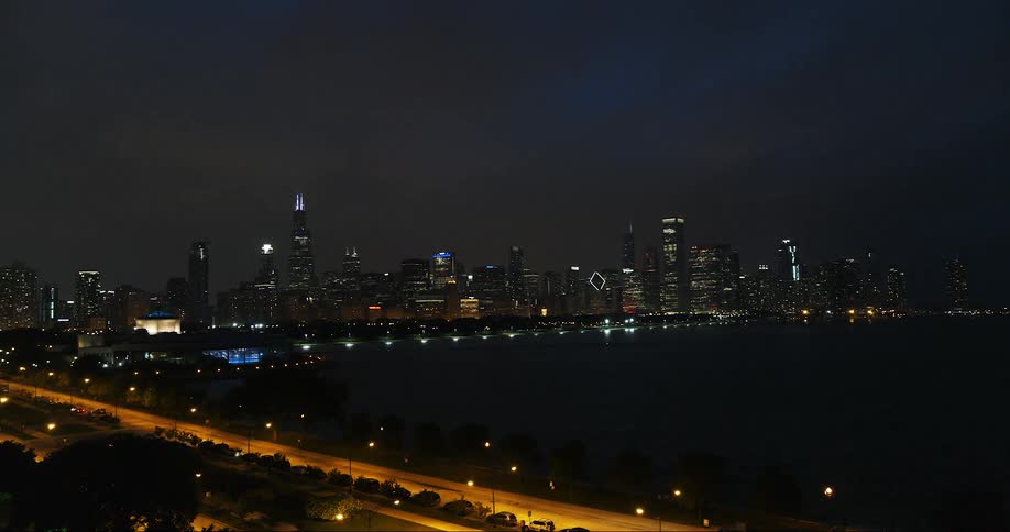 A city skyline at night in the distance