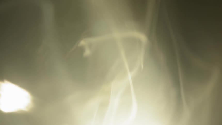 The smoke moves around the dark area