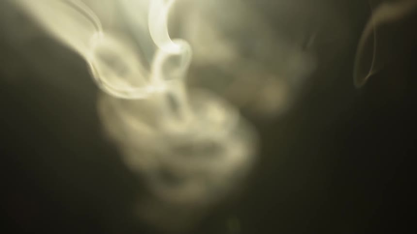 Smoke is twirling and curving in the air