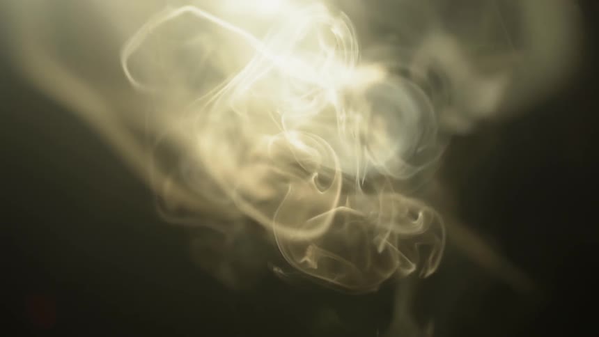 Smoke tendrils waft in bright light