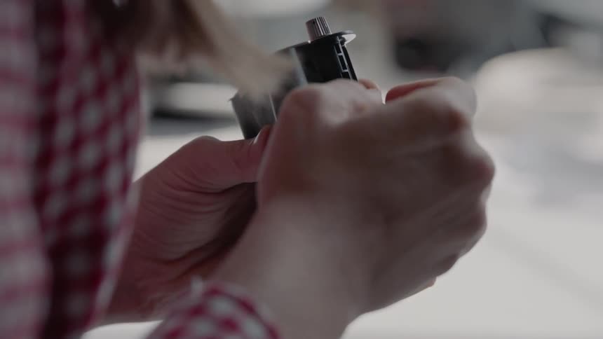 A woman loads film manually