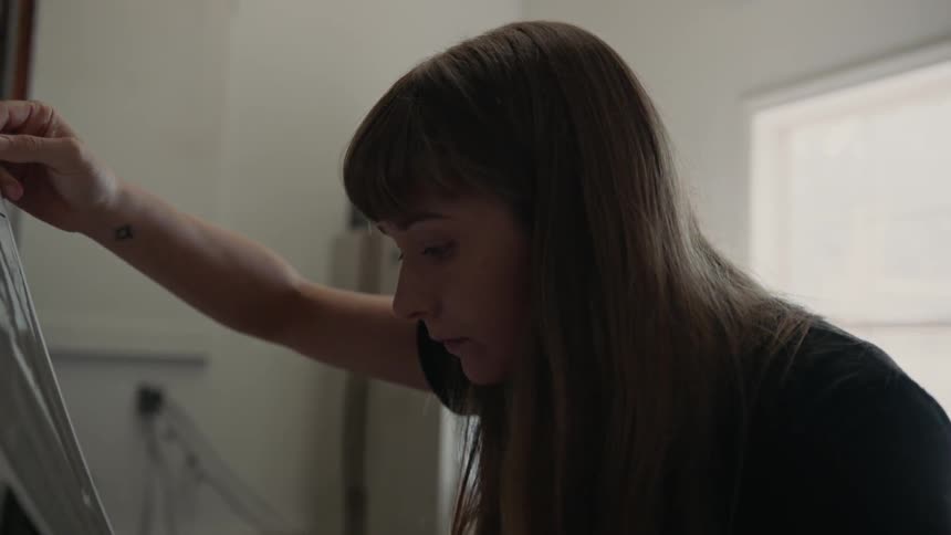 Woman examines photographic print