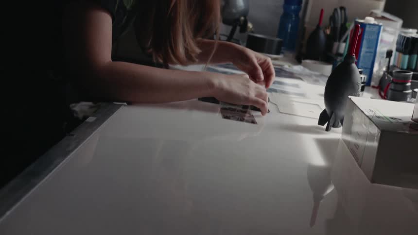 A woman works at a white desk