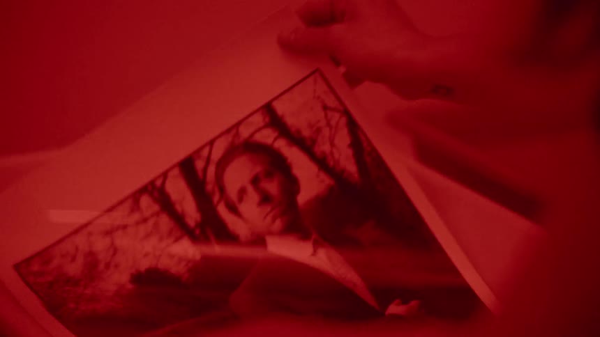 A photograph is developed in a darkroom