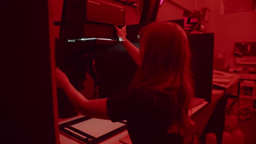 A woman is working in a dark room
